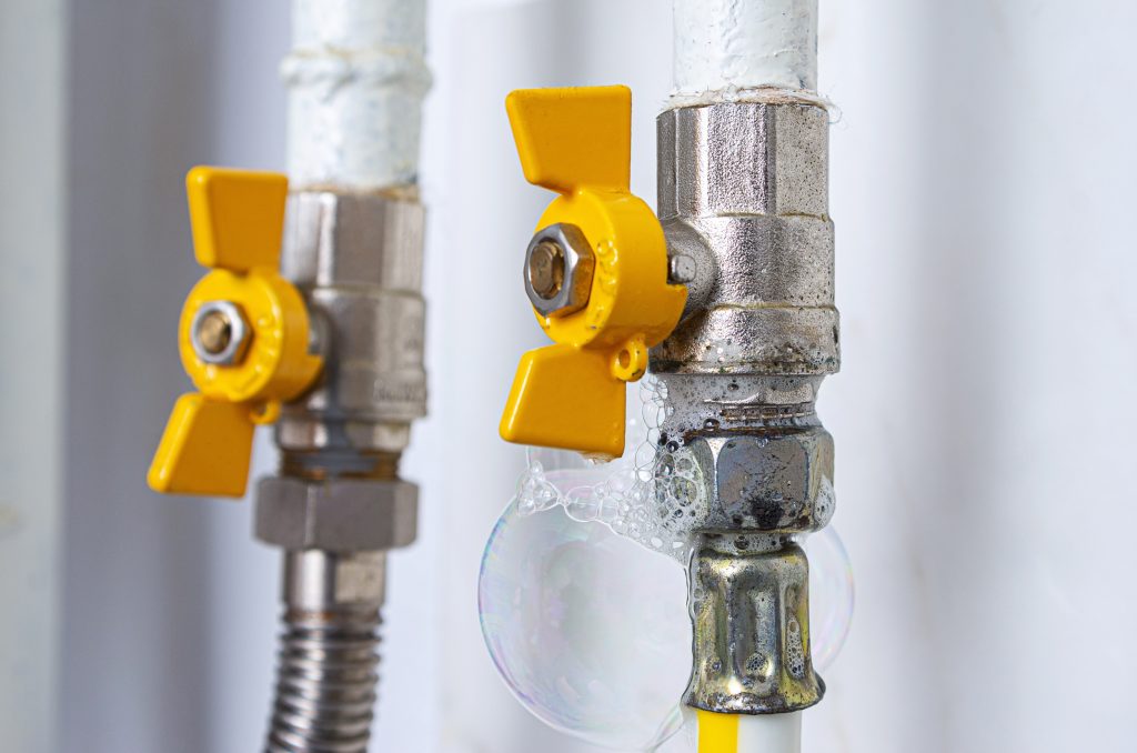 Gas,leak,at,home,kitchen.,inflating,bubbles,of,soap,mixture